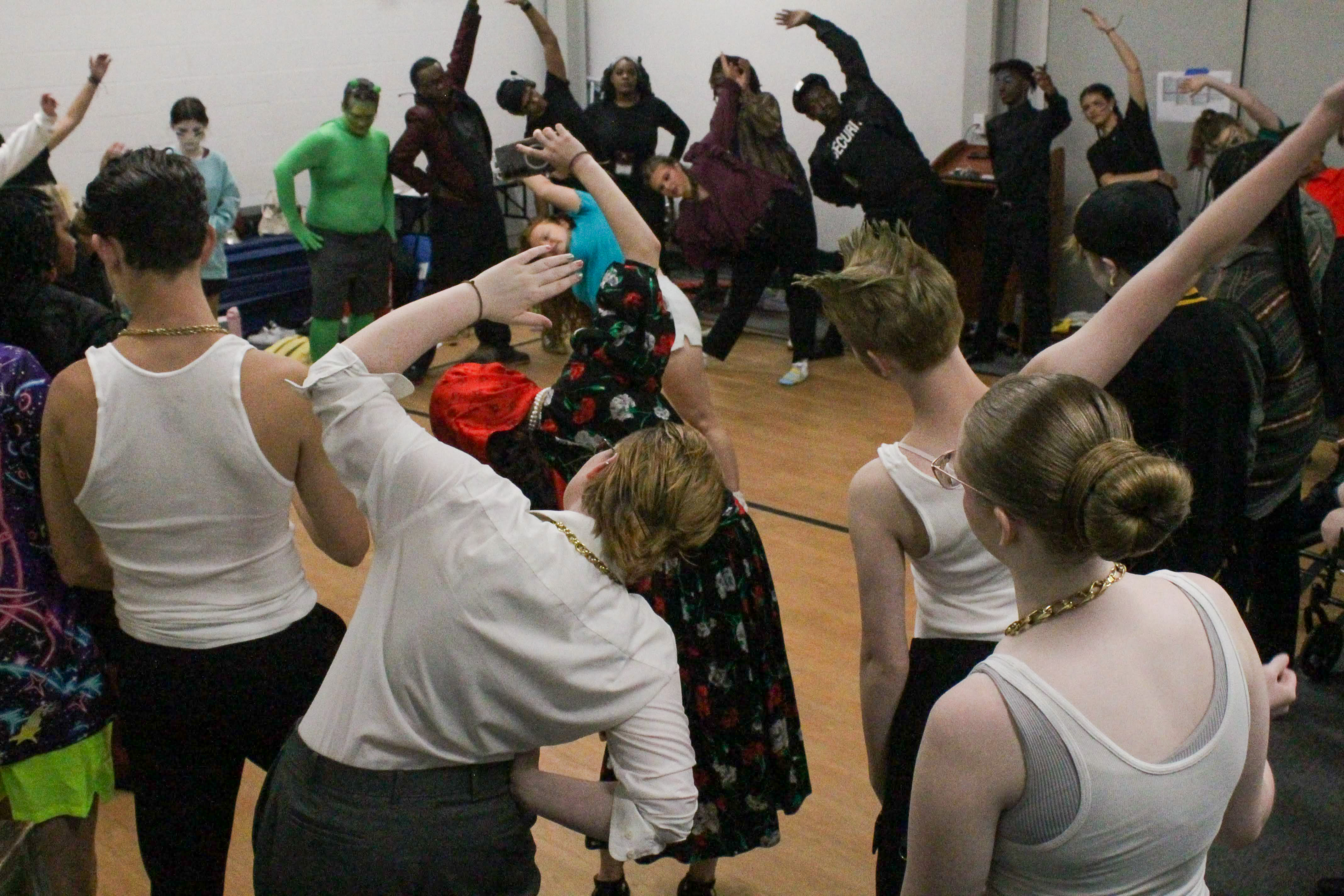 Students performing on stage under theatre lights
