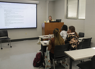 Students collaborating at a table during the Writing Track